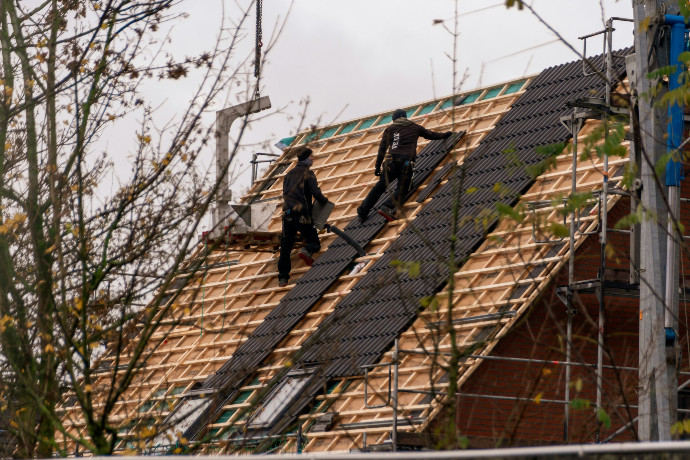 Roofing crew installing a new residential roof